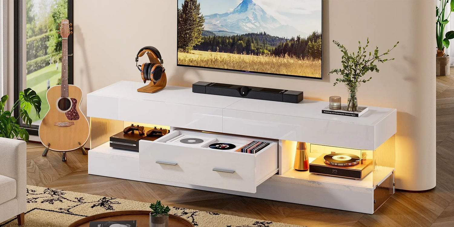 Modern white high-gloss TV stand with warm LED lights featuring a large drawer for CDs and open storage shelves.